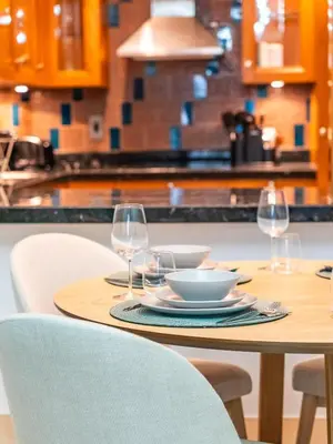 a table with two wine glasses and a bowl on it at Cozy 1BR- Yansoon 4- Heart of Downtown Dubai in Dubai