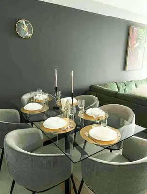 a dining room with a glass table and chairs at Luxury 2-bedroom in Dubai Marina with Sea View in Dubai