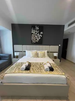 a bedroom with a large bed with shoes on it at Luxury 2-bedroom in Dubai Marina with Sea View in Dubai