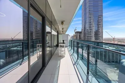 an empty balcony of a building with views of the city at C&L Homes Dubai Canal in Dubai