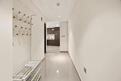 a hallway of a house with white walls and a staircase at C&L Homes Dubai Canal in Dubai