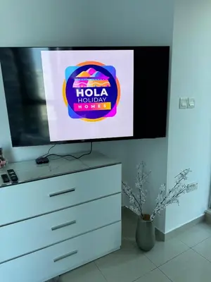 a flat screen tv sitting on top of a dresser at Modern Studio in Dubai Marina, JBR in Dubai
