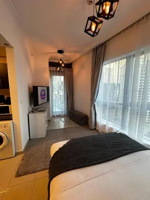 a bedroom with a bed and a living room at Modern Studio in Dubai Marina, JBR in Dubai