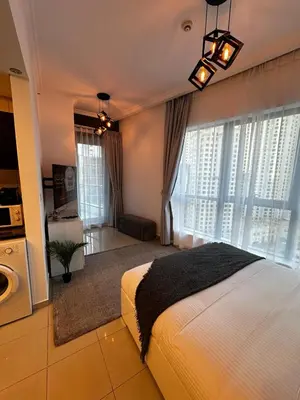 a bedroom with a bed and a large window at Modern Studio in Dubai Marina, JBR in Dubai