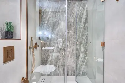 a shower with a glass door in a bathroom at Lux High-Rise Studio 12th Floor Westwood Grande in Dubai