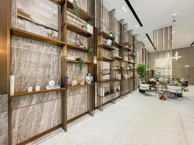 a lobby with wooden walls and a room with tables at Lux High-Rise Studio 12th Floor Westwood Grande in Dubai