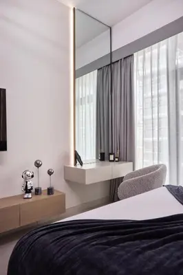 a bedroom with a large mirror and a bed at Lux High-Rise Studio 12th Floor Westwood Grande in Dubai
