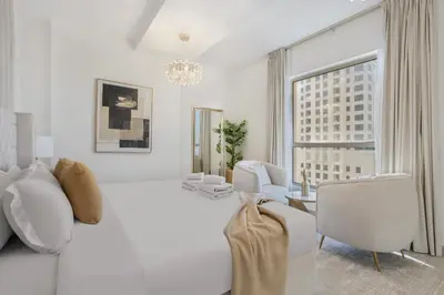 a living room with white furniture and a large window at Classy 2BR Apt in Shams1 Panoramic view in JBR in Dubai