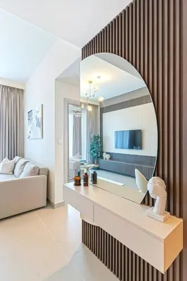 a bathroom with a large mirror on a wall at Sky-High Downtown 1BR Steps from Burj Khalifa in Dubai