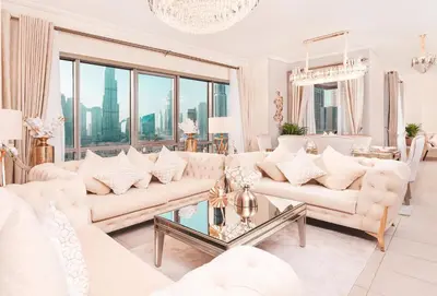 a living room with white furniture and a large window at Elite Royal Apartment - Sky Series - Luxurious in Dubai