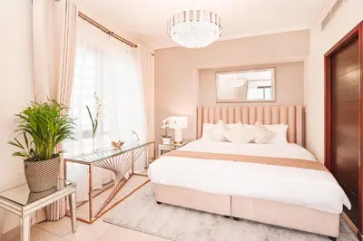 a bedroom with a large bed and a chandelier at Elite Royal Apartment - Sky Series - Luxurious in Dubai