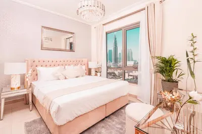 a white bedroom with a bed and a large window at Elite Royal Apartment - Sky Series - Luxurious in Dubai