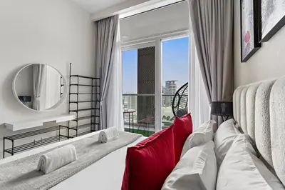 a bedroom with a couch and a large window at Sleek 1BR Apt with Pool Gym by Dubai Canal, Dubai Mall & Business Bay in Dubai