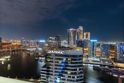 a view of a city at night with at Sleek 1BR Apt with Pool Gym by Dubai Canal, Dubai Mall & Business Bay in Dubai