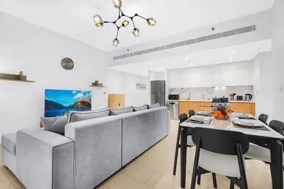 a dining room and kitchen with a table and chairs at Relaxing 1BR in Dubai With Access to Pool, Gym & Parking in Dubai