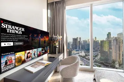 a room with a desk with a large window at Luxury 4BR Prime Downtown Stay in Dubai
