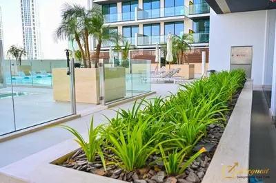 a courtyard in a building with palm trees at Stunning 1BR in JVC Binghatti Amber by Deleguest in Dubai