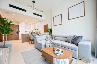 a living room with a couch and a table at Stunning 1BR in JVC Binghatti Amber by Deleguest in Dubai