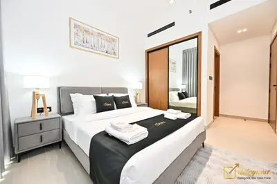 a bedroom with a large bed with towels on it at Stunning 1BR in JVC Binghatti Amber by Deleguest in Dubai