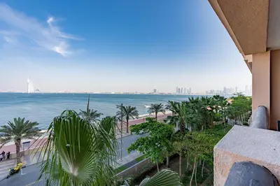 a view of the ocean from a balcony of a building at Burj & Sea View King 2 Bedroom Apartment In Anantara Resort in Dubai