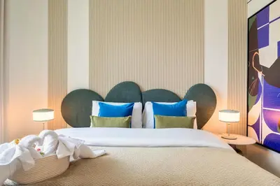 a bedroom with a large bed with blue pillows at Vibrant Luxe Burj Khalifa Views-Dubai Mall Access by Maxx Value Homes in Dubai