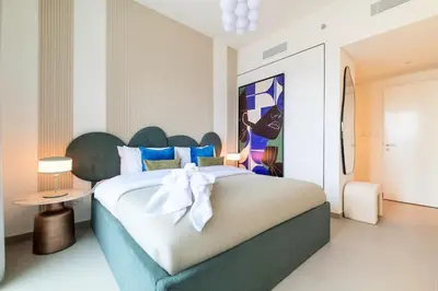 a bedroom with a large bed with a white bow on it at Vibrant Luxe Burj Khalifa Views-Dubai Mall Access by Maxx Value Homes in Dubai