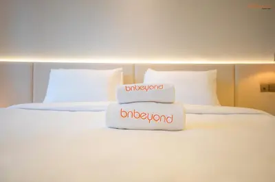 a stack of towels sitting on top of a bed at Bnbeyond's Luxury Vibe & Burj View in Dubai