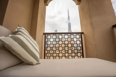 a bed with a window with a view of the bur mosque at Bnbeyond's Luxury Vibe & Burj View in Dubai