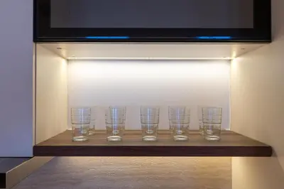 a row of glasses sitting on a shelf in a wall at King 2 Bedroom Jumeirah Beach & Dubai Eye Views in Dubai