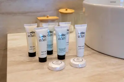 a group of four bottles of hair products on a counter at King 2 Bedroom Jumeirah Beach & Dubai Eye Views in Dubai