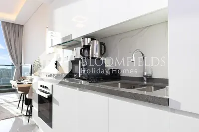 a kitchen with a sink and a counter top at Bloomfields Charming Stu in Samana View in Dubai