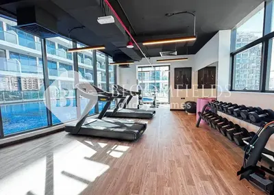a gym with cardio equipment in a building at Bloomfields Charming Stu in Samana View in Dubai