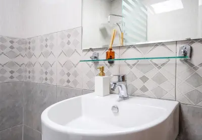 a bathroom with a white sink and a mirror at Lavish 1 bedroom in Dubai