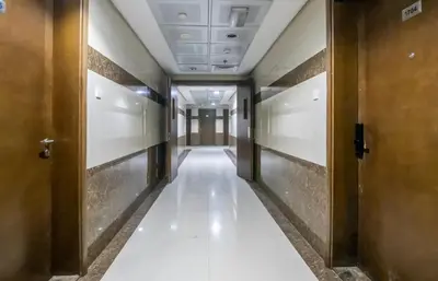 a corridor of an office building with a long hallway at Lavish 1 bedroom in Dubai
