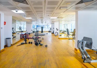 a gym with several exercise bikes and treadmills at Lavish 1 bedroom in Dubai