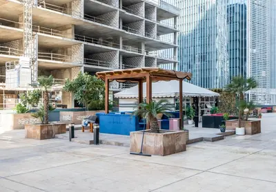 a pavilion with palm trees in front of a building at Lavish 1 bedroom in Dubai