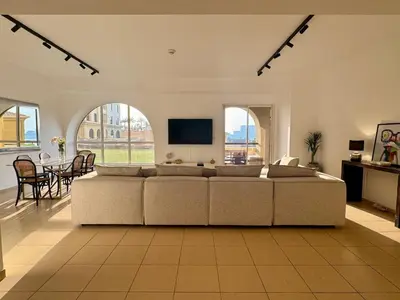 a large living room with a couch and a table at Large 5-BR JBR Apartment, Perfect for Families, Easy Beach Access in Dubai