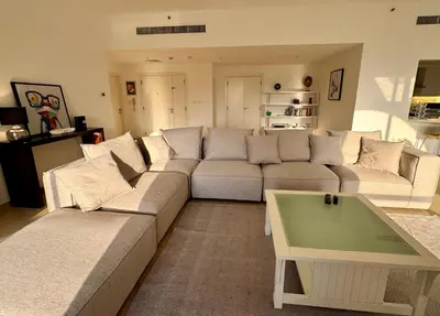 a living room with a couch and a coffee table at Large 5-BR JBR Apartment, Perfect for Families, Easy Beach Access in Dubai