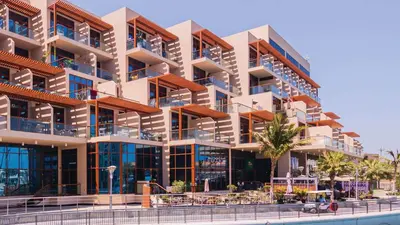 an apartment building with balconies and a pool at Silkhaus Seaside Studio in Palm Views West Tower in Dubai