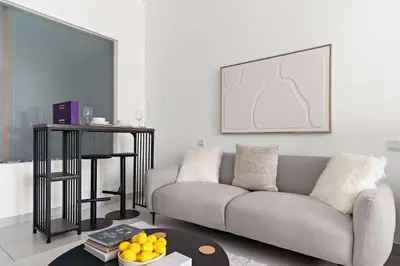 a living room with a couch and a table at Silkhaus Seaside Studio in Palm Views West Tower in Dubai