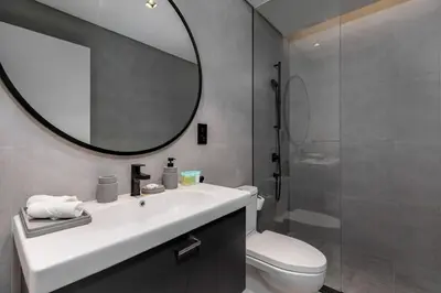 a bathroom with a sink and a mirror and a toilet at Waves - Tranquil Waterfront Living 2B Retreat With Balcony in Dubai