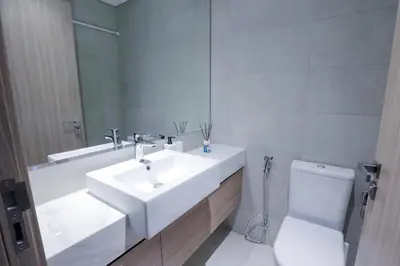 a bathroom with a white sink and a toilet at Azizi Riviera 42 - Meydan by Golden Casa in Dubai