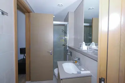 a bathroom with a sink and a shower at Sobha Hartland Waves-912 in Dubai
