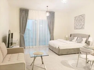 a bedroom with a bed and a couch and a table at SUPERIOR STAY HOLIDAY HOMES - Sleek & Modern Studio in Business Bay in Dubai