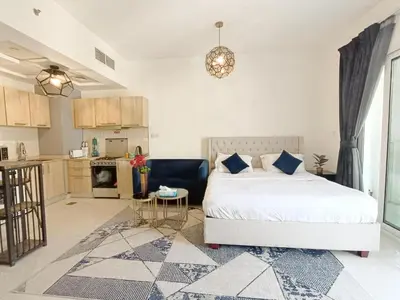 a bedroom with a bed and a kitchen at SUPERIOR STAY HOLIDAY HOMES - Sleek & Modern Studio in Business Bay in Dubai