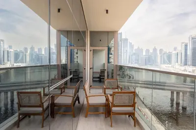 a balcony with chairs and a view of the city at Canal View, Partial Burj Khalifa View in Dubai