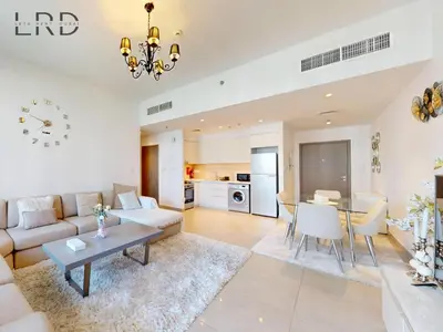 a living room with a couch and a table at Luxurious 1BR Apartment with Creek View in Dubai