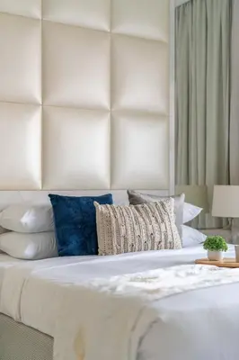 a bedroom with a large white bed with pillows at GuestReady - Peaceful Skyline at Signature Tower in Dubai