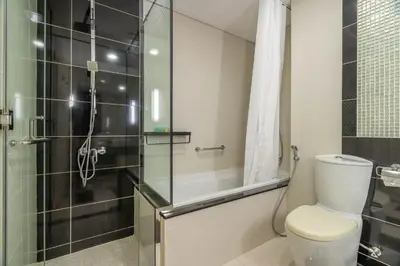 a bathroom with a toilet and a glass shower at GuestReady - Peaceful Skyline at Signature Tower in Dubai