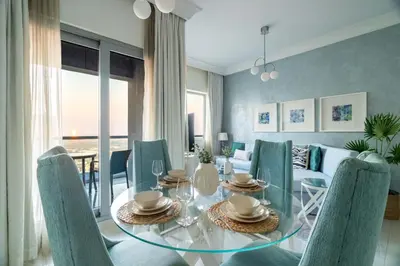 a dining room with a glass table and chairs at GuestReady - Peaceful Skyline at Signature Tower in Dubai